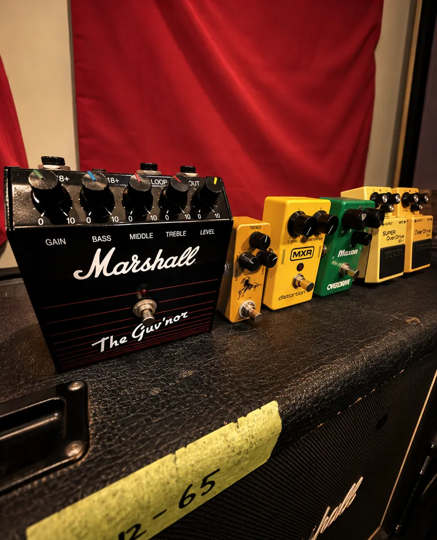 Overdrive and distortion pedals lined up on an amp.